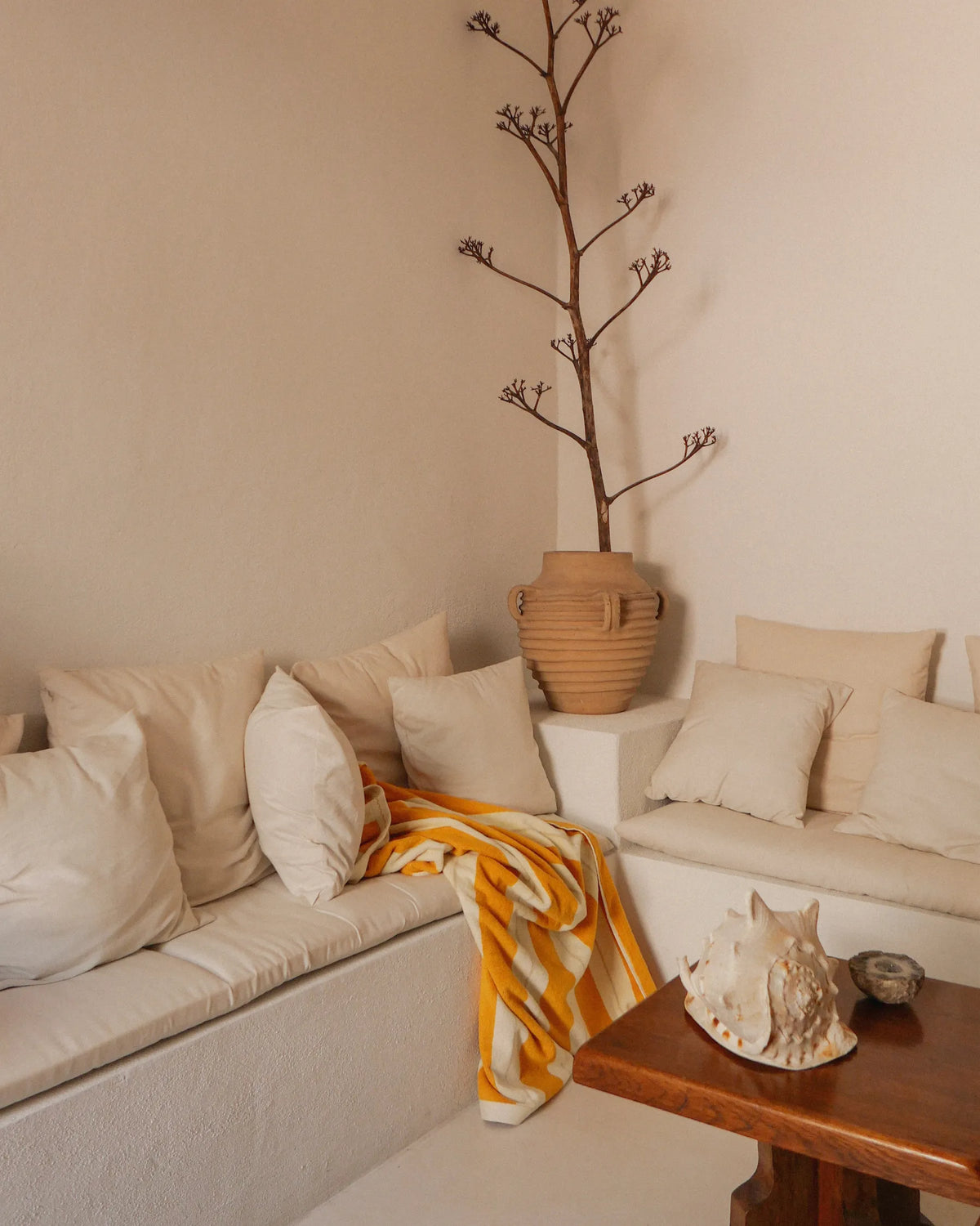Mediterranean interior with built-in seating and Éteanne striped beach towel in Tuscan Sun