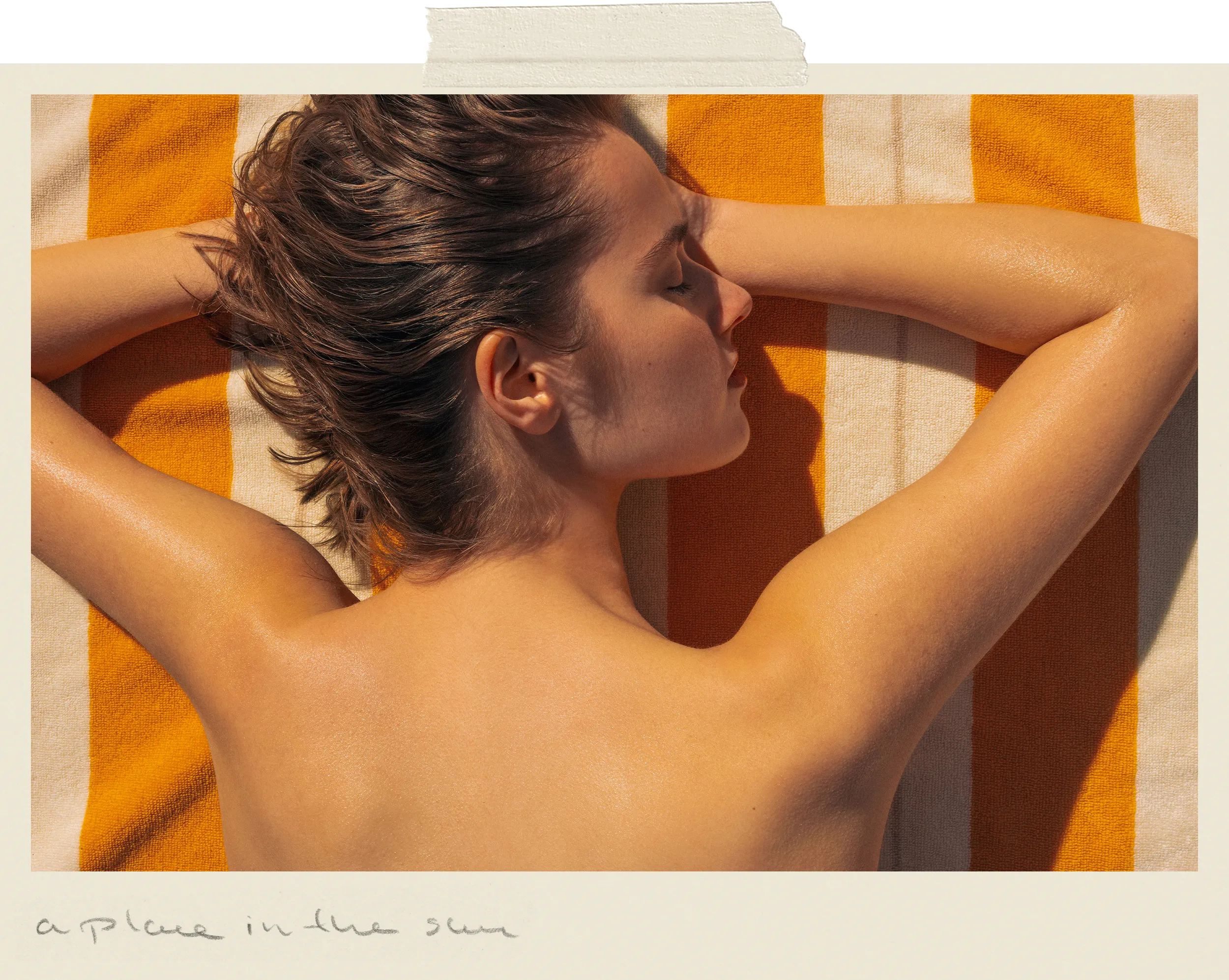 Woman resting on Éteanne Anné striped beach towel in Tuscan Sun