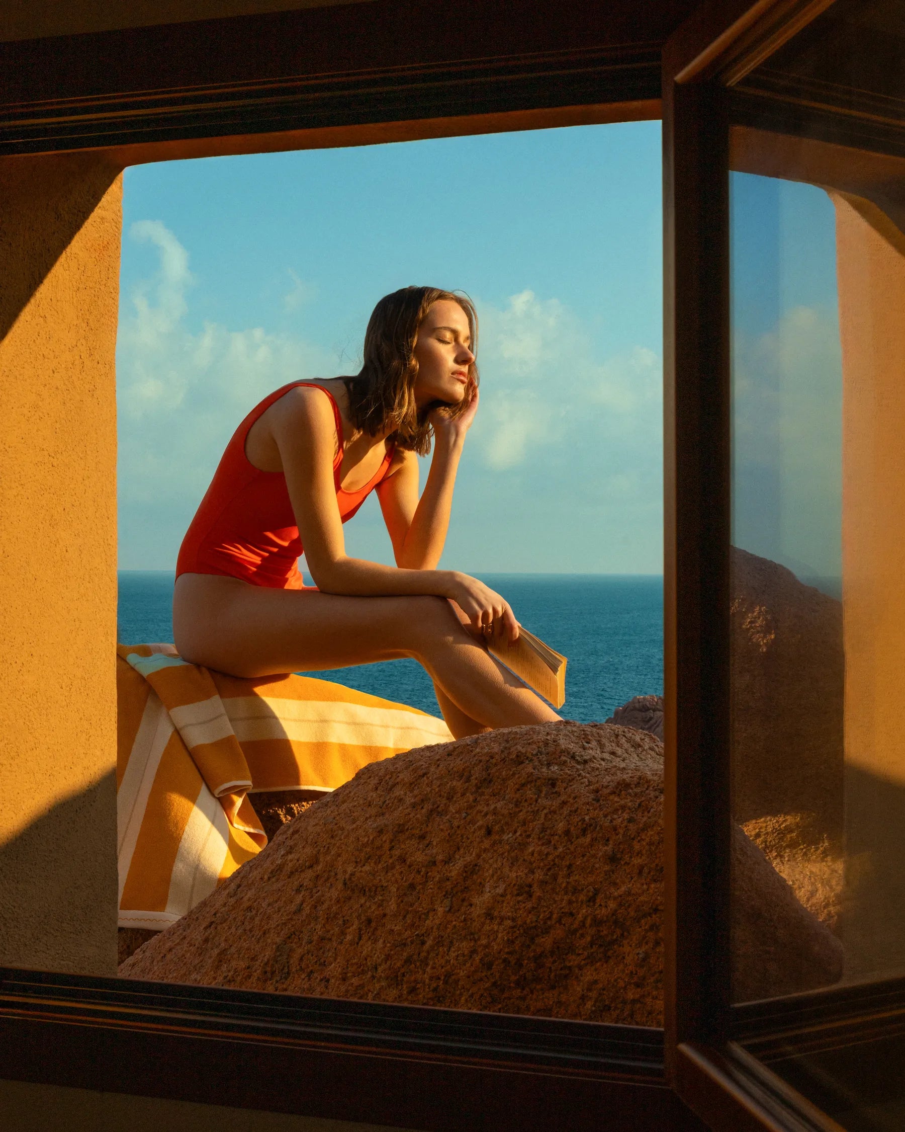 Woman in Éteanne striped beach towel in Tuscan Sun by Mediterranean window