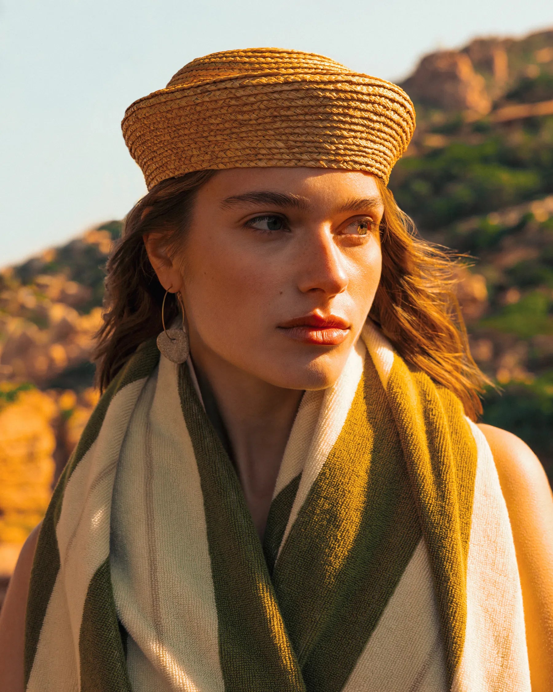 Portrait of woman wrapped in Éteanne Anné striped towel in Terre Verte