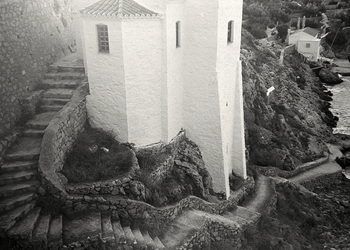 Whitewashed Mediterranean architecture overlooking a rocky coastline