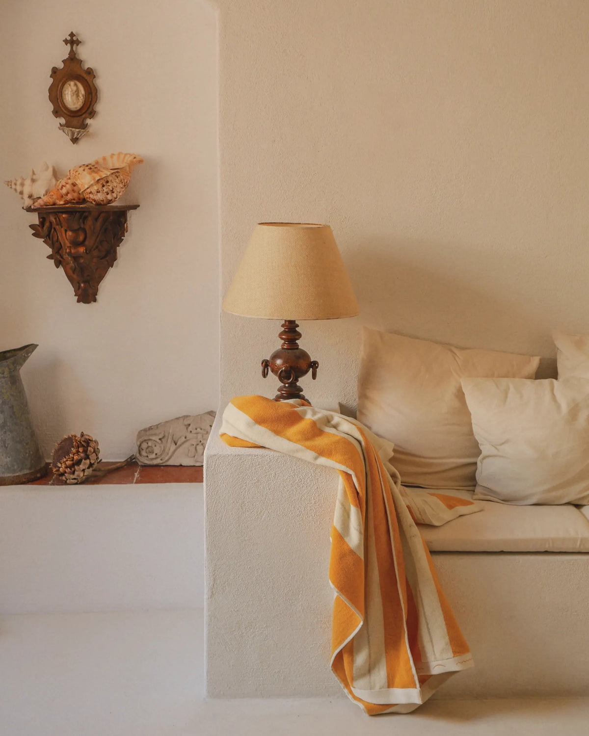 Éteanne striped beach towel in Tuscan Sun draped over built-in seating