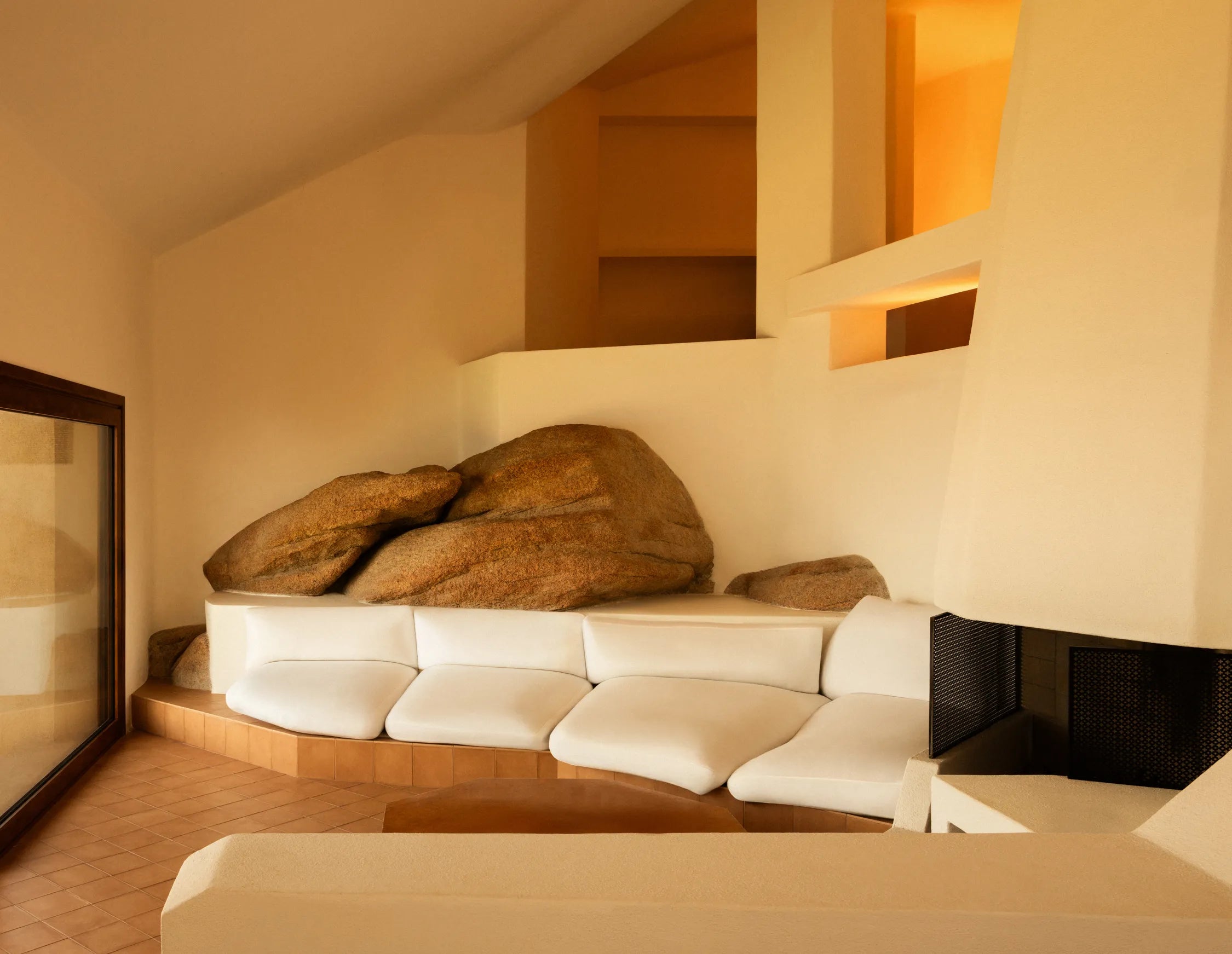 living room with built-in seating and granite boulders at Casa Scalesciani.