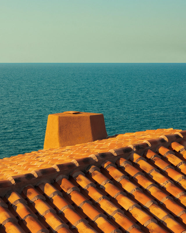 Terracotta roof of Casa Scalesciani with the Mediterranean Sea in the background.