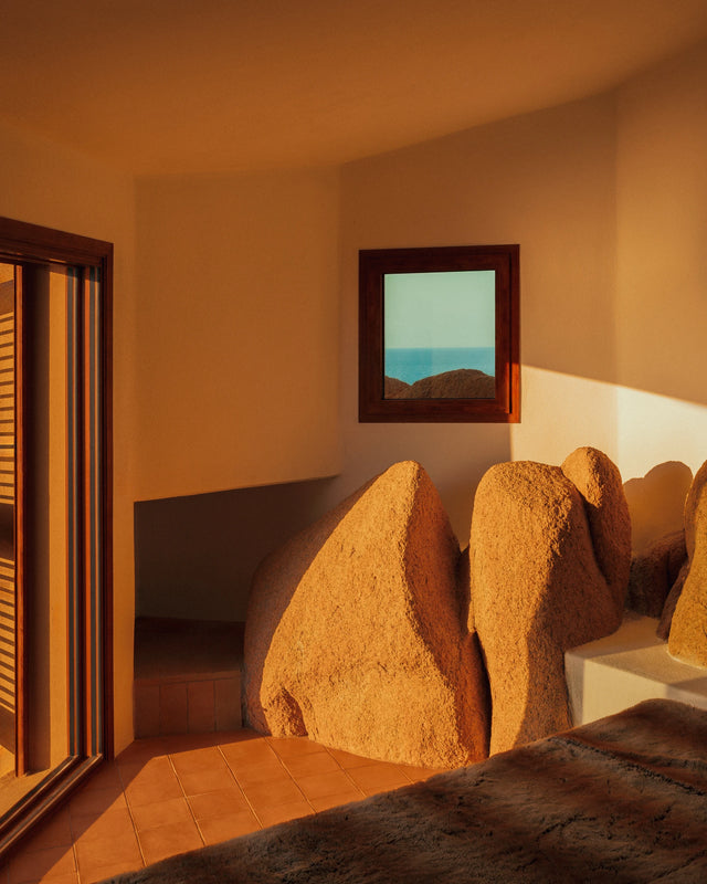 Minimal bedroom interior with sea view at Casa Scalesciani in Sardinia.