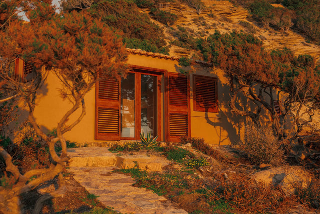 Exterior façade of Casa Scalesciani surrounded by Mediterranean vegetation