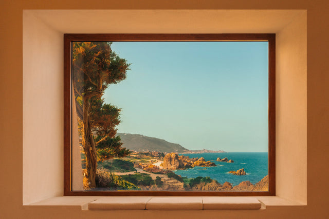Window framing the coastline from inside Casa Scalesciani in Costa Paradiso, Sardinia.