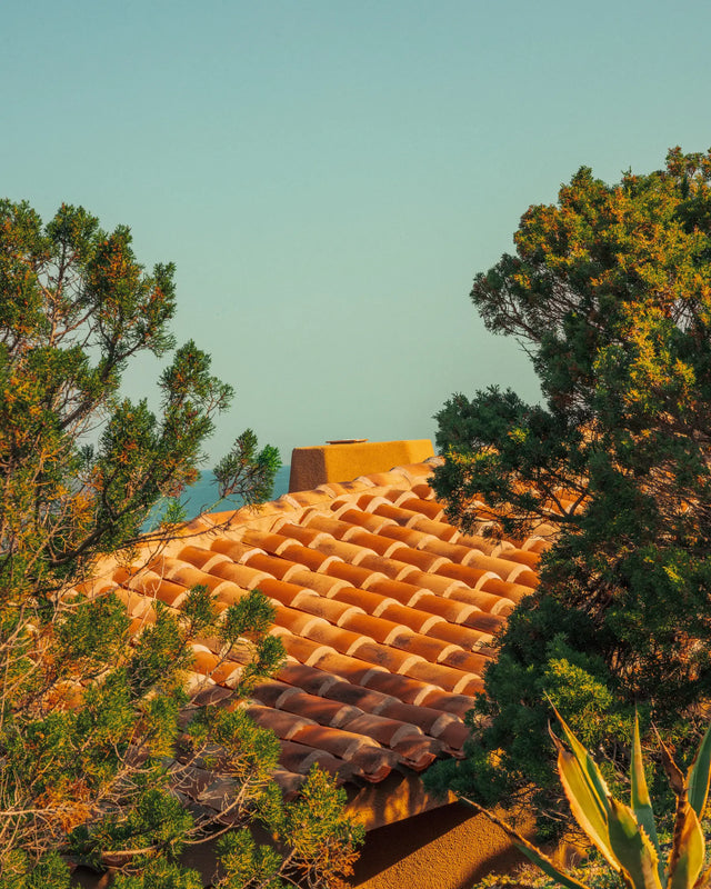 Terracotta roof of Casa Scalesciani with the Mediterranean Sea in the background.