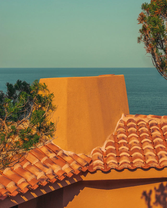 Terracotta roof of Casa Scalesciani with the Mediterranean Sea in the background.