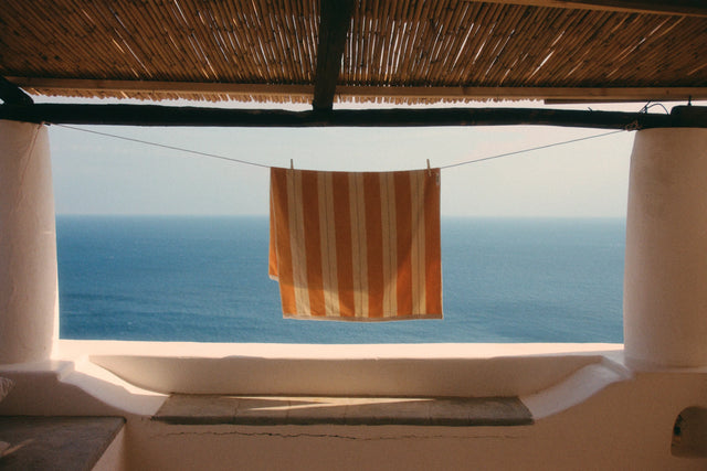 Anne Beach Towel in Tuscan Sun line drying overlooking the Mediterranean Sea.