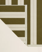 Folded striped beach towel in terre verte and ionian pearl showing thickness and softness