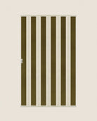 Striped beach towel in Terre Verte and Ioanian Pearl, laid flat on a neutral background