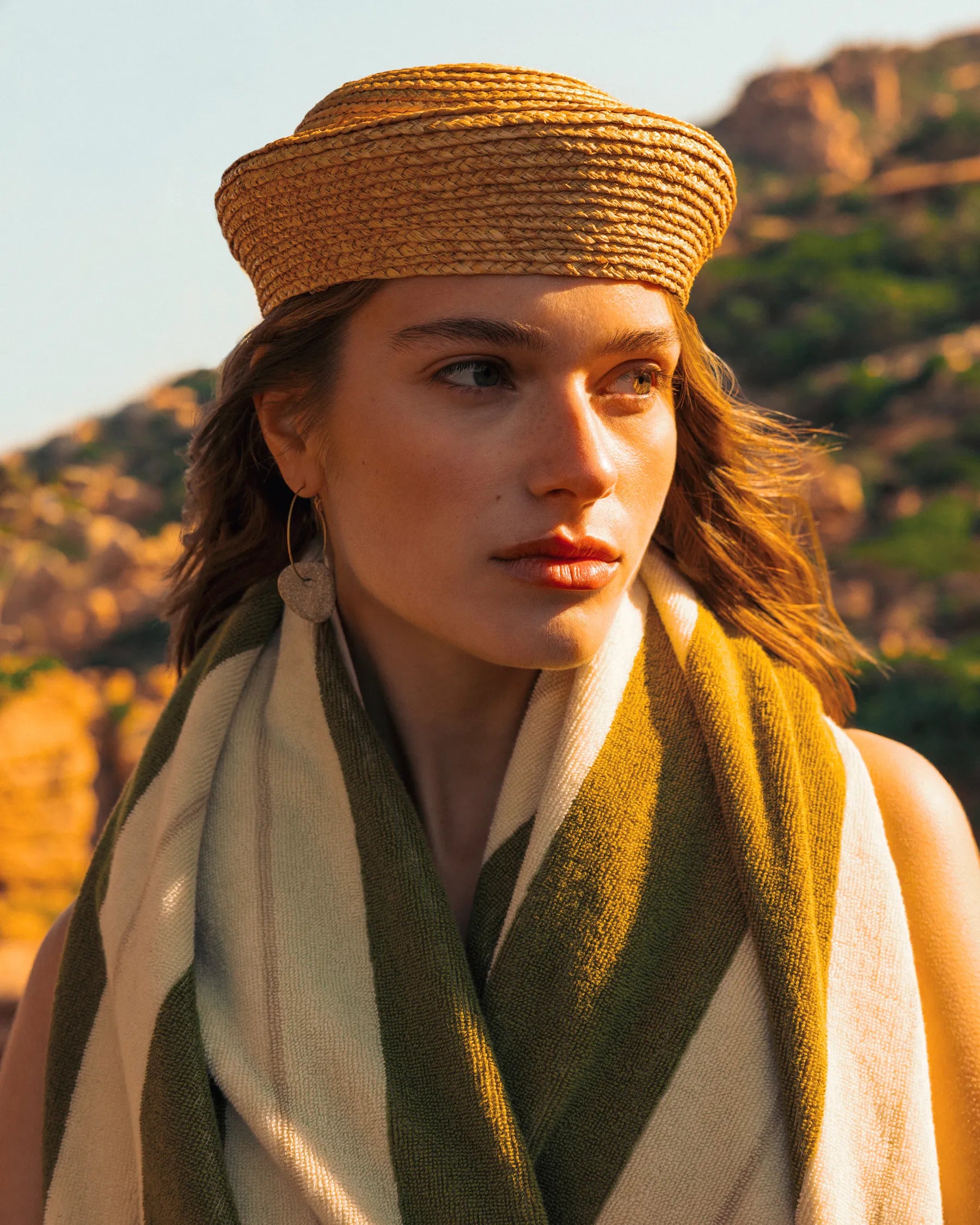 Portrait of woman wrapped in Éteanne Anné striped towel in Terre Verte