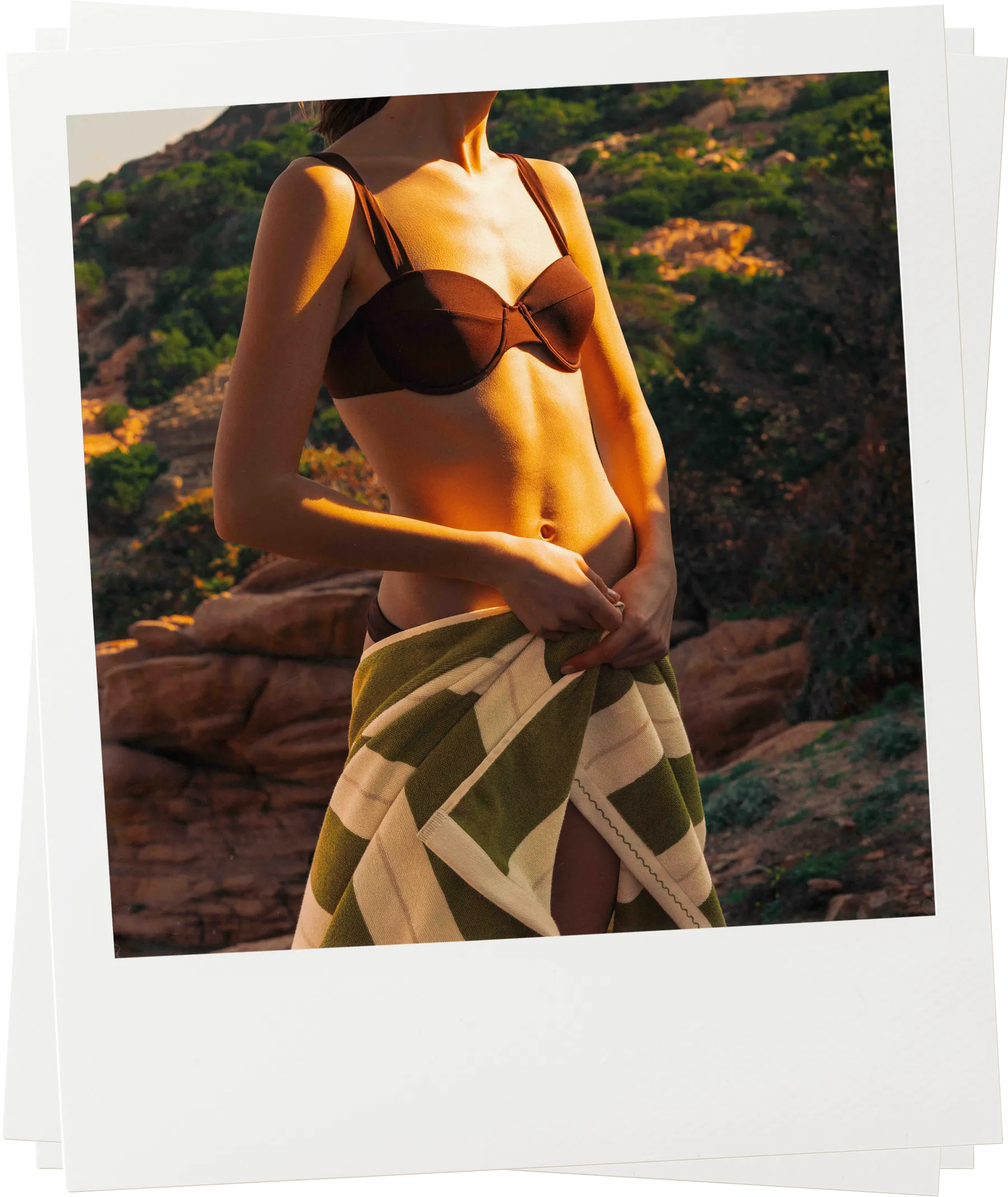 Woman wearing Éteanne Anné striped beach towel in Terre Verte around waist