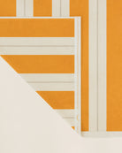 Folded striped beach towel in tuscan sun and ionian pearl showing thickness and softness