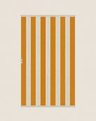 Striped beach towel in Tuscan Sun and Ioanian Pearl, laid flat on a neutral background