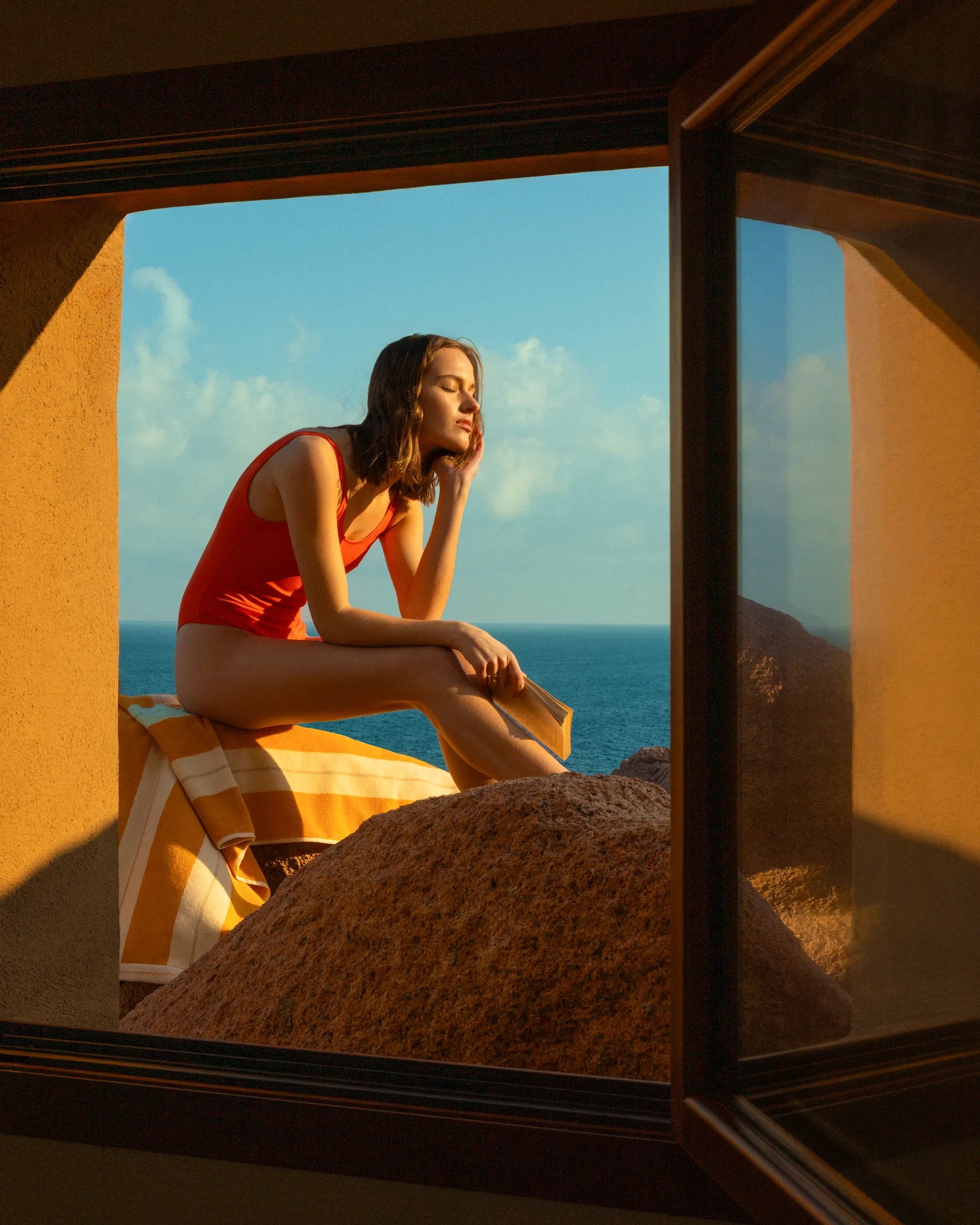 Woman in Éteanne striped beach towel in Tuscan Sun by Mediterranean window