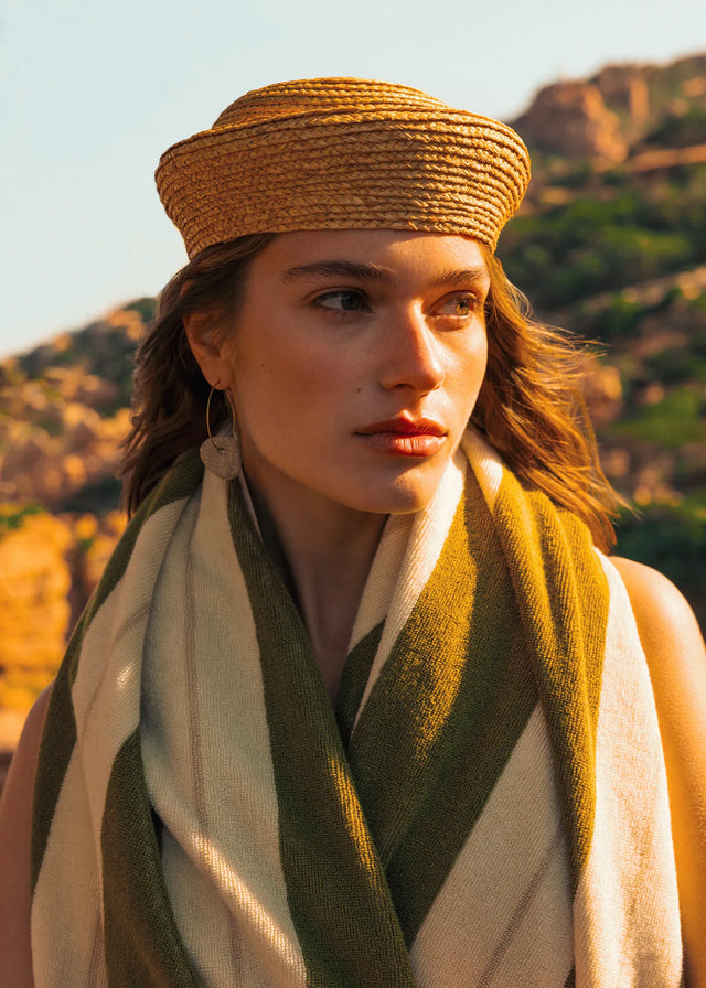 Portrait of woman wrapped in Éteanne Anné striped towel in Terre Verte