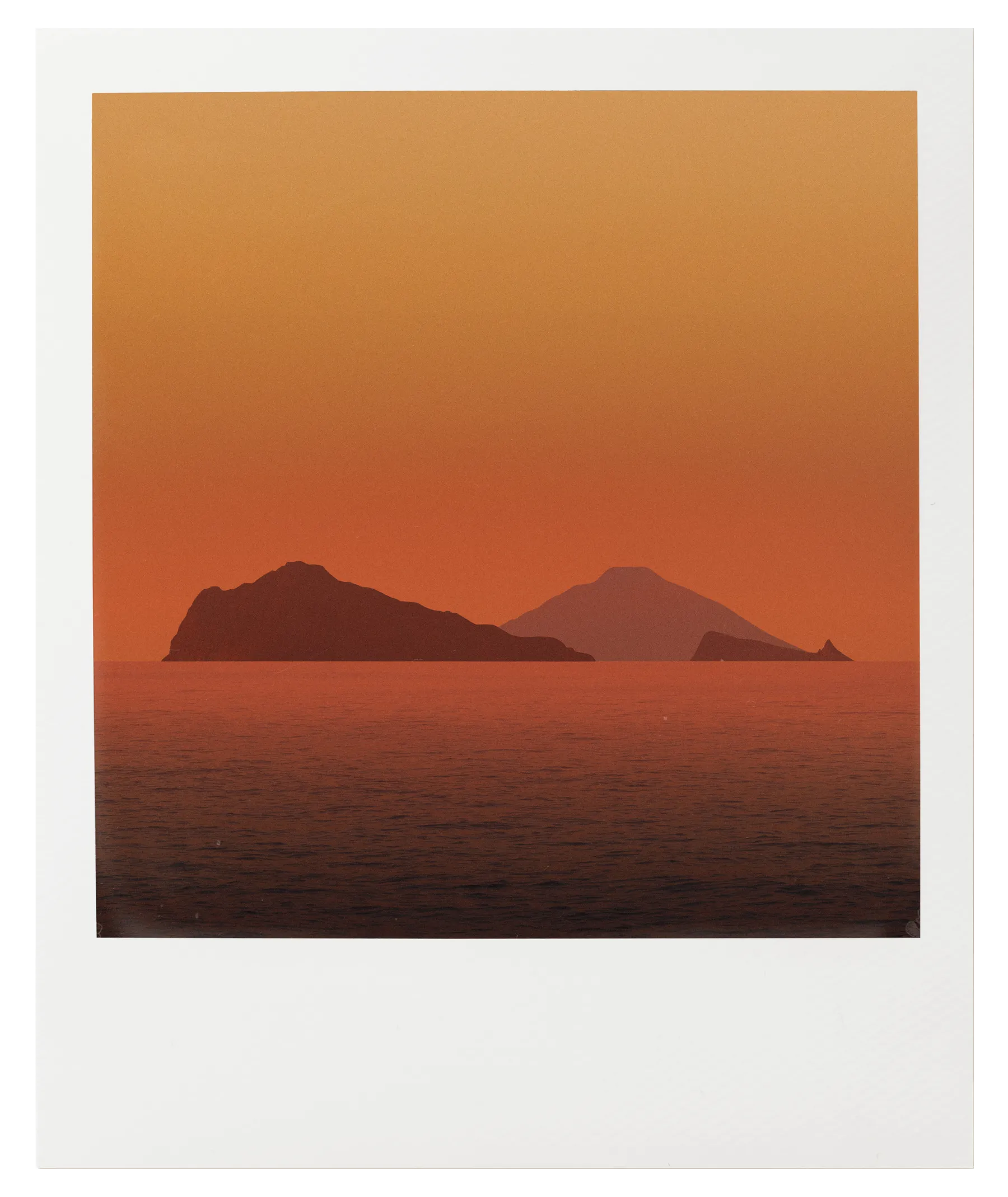 Mediterranean sunset over sea and islands in warm orange tones